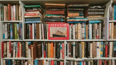 a large book shelf overflowing with older books