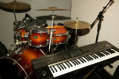drums, a microphone stand and an electric keyboard
