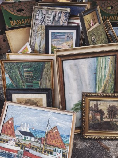 pile of framed artwork
